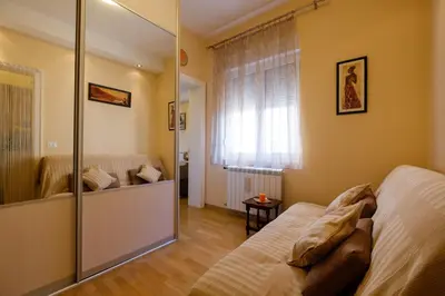 a bedroom with a bed and a mirror at Jolie in Belgrade