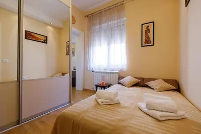 a bedroom with a large bed with towels on it at Jolie in Belgrade