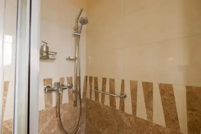 a shower with a hose in a bathroom at Jolie in Belgrade