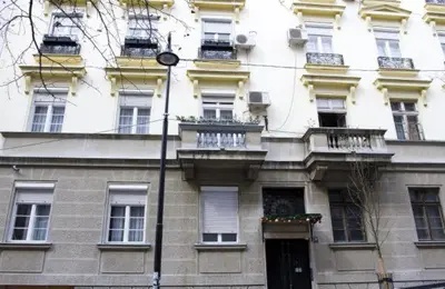 a large white building with windows and balconies at Crown apartment with garden view in Belgrade