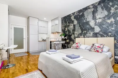 a bedroom with a large bed with towels on it at Loko Savada in Belgrade