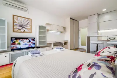 a room with a bed and a flat screen tv at Loko Savada in Belgrade