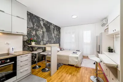 a small kitchen with a bed in a room at Loko Savada in Belgrade