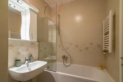 a bathroom with a sink and a shower and a tub at Loko Savada in Belgrade