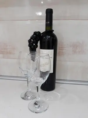 a bottle of wine and two wine glasses on a table at Sweet Yellow Apartment in Belgrade