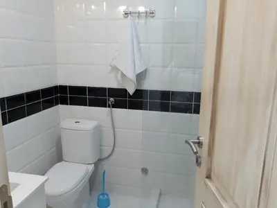 a bathroom with a white toilet and a sink at Sweet Yellow Apartment in Belgrade