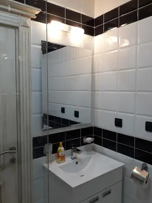 a bathroom with a sink and a mirror at Sweet Yellow Apartment in Belgrade