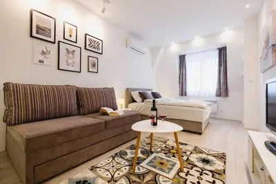 a living room with a couch and a bed at Apartment Hana Lux-Cozy Studio Near Danube, Quite & Bright in Belgrade