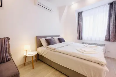 a bedroom with a large bed and a window at Apartment Hana Lux-Cozy Studio Near Danube, Quite & Bright in Belgrade
