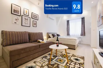a living room with a couch and a table at Apartment Hana Lux-Cozy Studio Near Danube, Quite & Bright in Belgrade