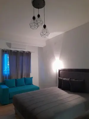 a bedroom with a bed and a blue couch at Anni in Belgrade
