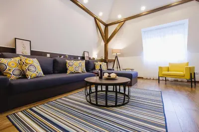 a living room with a blue couch and a table at Apartment Lea Lux-5 min to Danube, Quite & Cozy, Easy parking nearby in Belgrade