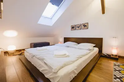 a large white bed in a room with a skylight at Apartment Lea Lux-5 min to Danube, Quite & Cozy, Easy parking nearby in Belgrade