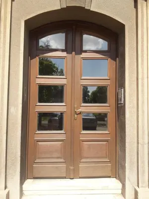 a wooden door with three windows on a building at Apartment Lea Lux-5 min to Danube, Quite & Cozy, Easy parking nearby in Belgrade