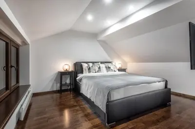 a bedroom with a large bed in a attic at ONE Apartment in Belgrade
