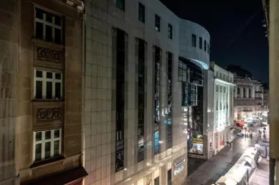 a building on a city street at night at ONE Apartment in Belgrade