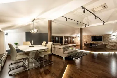 a living room with a table and chairs and a couch at ONE Apartment in Belgrade