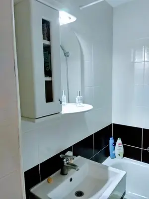 a white bathroom with a sink and a mirror at Sobe Neva in Belgrade