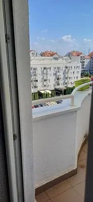 a balcony with a view of a large building at Sobe Neva in Belgrade