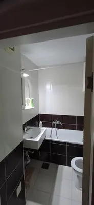 a bathroom with a sink and a tub and a toilet at Sobe Neva in Belgrade