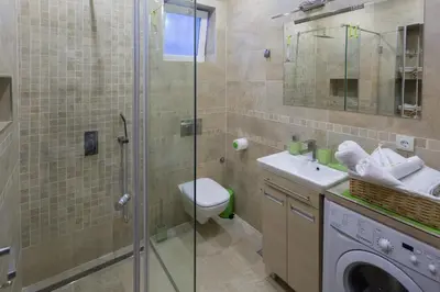 a bathroom with a shower and a toilet and a sink at Cosmopolitan One Apartment in Belgrade