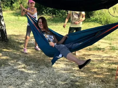 a woman is sitting in a hammock at Branch in Arandjelovac