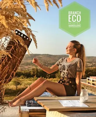 a woman sitting on a table with her legs crossed at Branch in Arandjelovac
