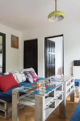 a living room with a table and a couch at Branch in Arandjelovac
