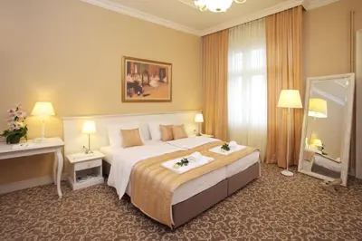 a hotel room with a large bed and a mirror at Booking Rooms in Belgrade