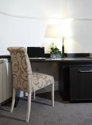 a desk with a chair and a laptop on it at Booking Rooms in Belgrade