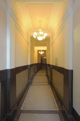 an empty hallway in a building with a ceiling at Booking Rooms in Belgrade