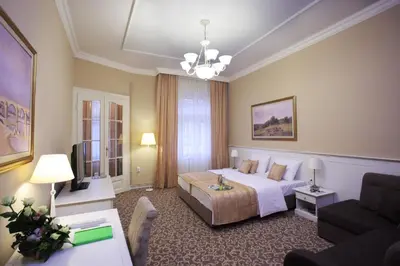 a hotel room with a bed and a couch at Booking Rooms in Belgrade