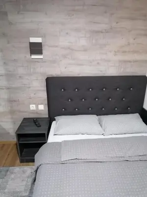 a bedroom with a large bed with a head board at Prenoćište Day Holiday in Smederevo