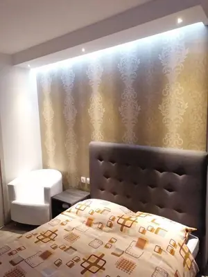a bedroom with a bed with a head board at Prenoćište Day Holiday in Smederevo