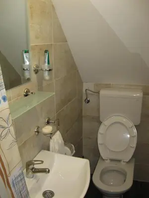 a small bathroom with a toilet and a sink at Prenoćište Day Holiday in Smederevo