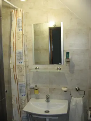 a bathroom with a sink and a mirror at Prenoćište Day Holiday in Smederevo