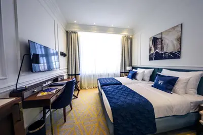a hotel room with a bed and a desk and a television at Hotel Centar No.1 in Belgrade