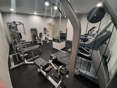 a gym with several treadmills and machines in it at Hotel Centar No.1 in Belgrade