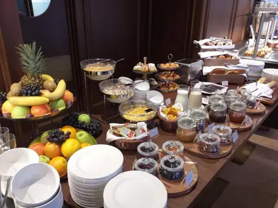 a buffet with fruit and other food on a table at Hotel Centar No.1 in Belgrade