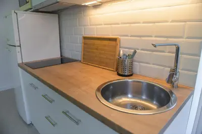 a kitchen counter with a sink in a kitchen at Puzzle Apartment in Dedinje