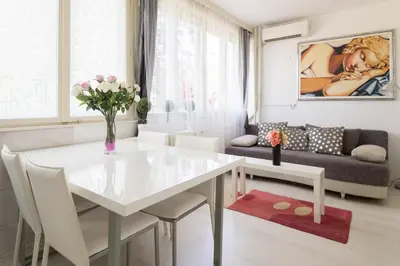 a white table and chairs in a living room at GRACE in Tošin Bunar