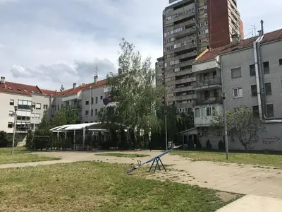 a playground in the middle of a city with buildings at Apartment Delta Sava New Belgrade in Belgrade