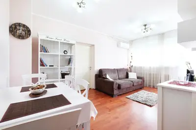 a living room with a table and a couch at Belgrade Sweet Home Apartment in Belgrade