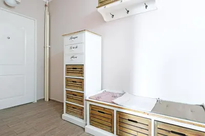 a room with a bed and wooden drawers at Belgrade Sweet Home Apartment in Belgrade