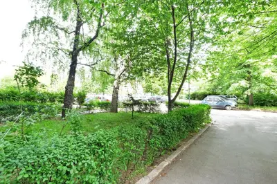 a car parked on the side of a road with trees at Belgrade Sweet Home Apartment in Belgrade