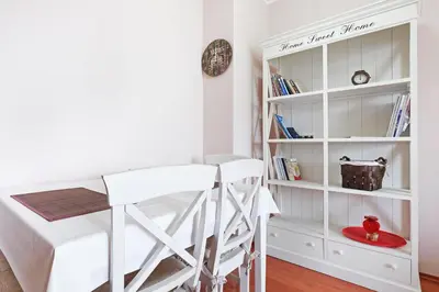 a room with a desk and a white book shelf at Belgrade Sweet Home Apartment in Belgrade