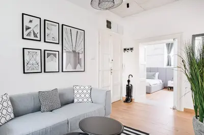 a living room with a couch and a table at HostGost Selected Suites - Molerova 9 in Belgrade