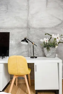 a desk with a lamp and a yellow chair at HostGost Selected Suites - Molerova 9 in Belgrade