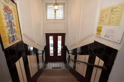 a hallway with a staircase with a door and a window at HostGost Selected Suites - Molerova 9 in Belgrade