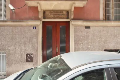 a car parked in front of a building with a red door at HostGost Selected Suites - Molerova 9 in Belgrade